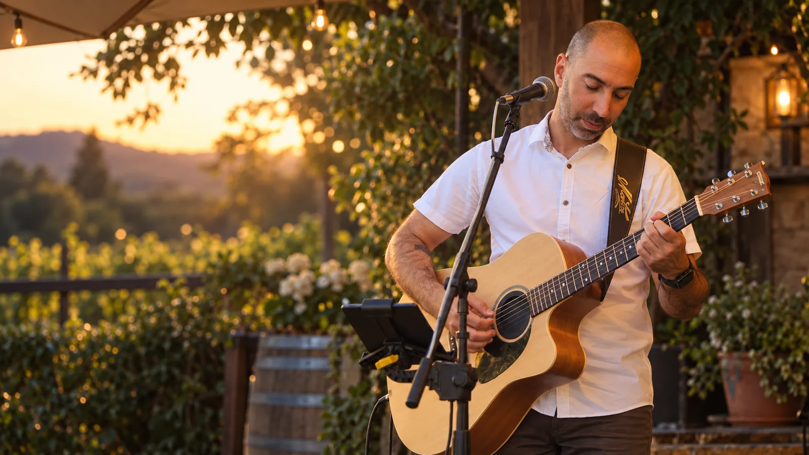 Dan playing acoustic guitar outdoors in warm evening light